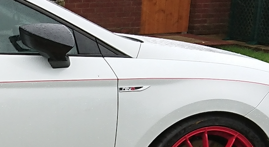 A car parked in front of a building
Description automatically generated