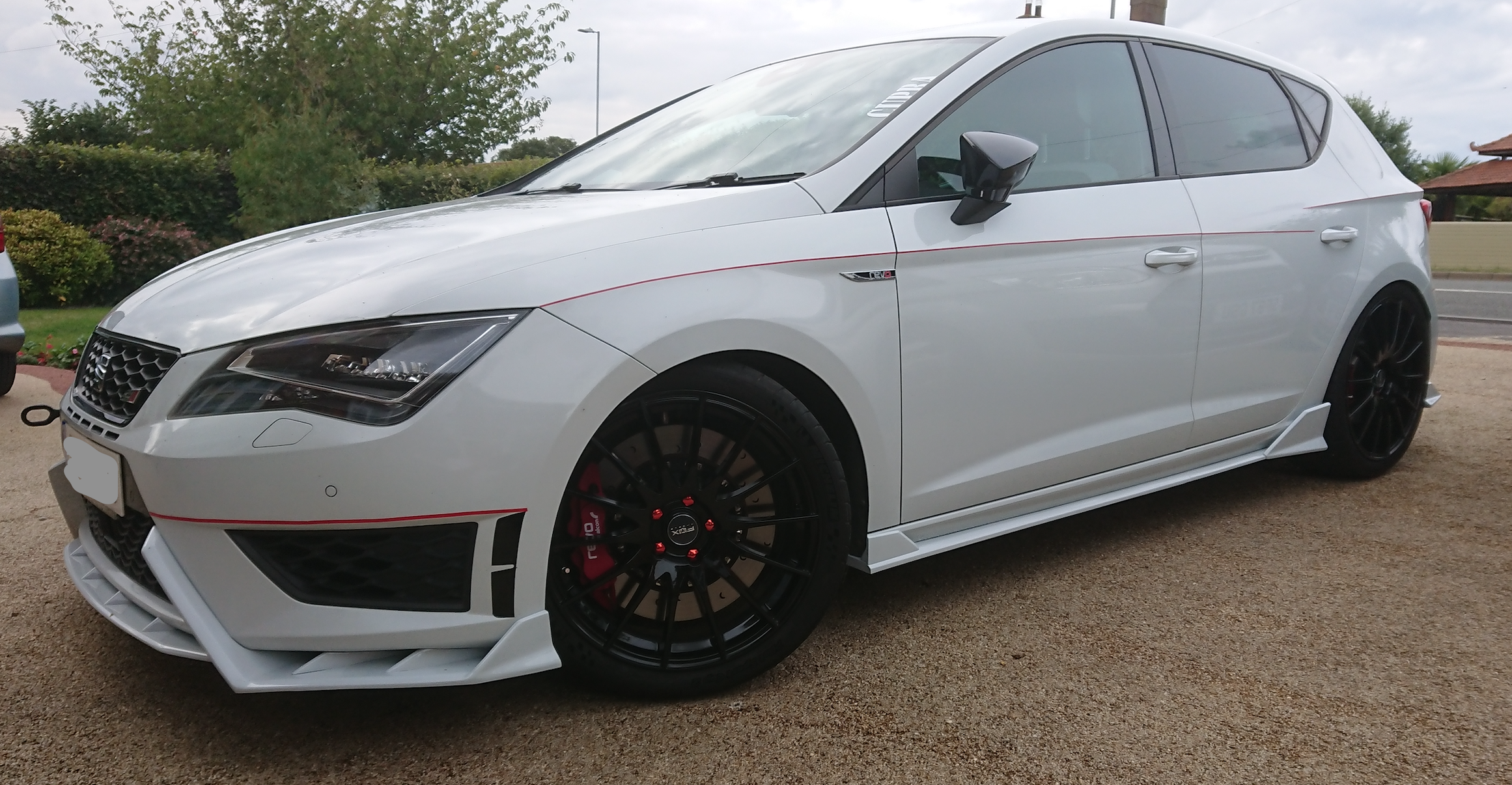 A car parked in a parking lot
Description automatically generated