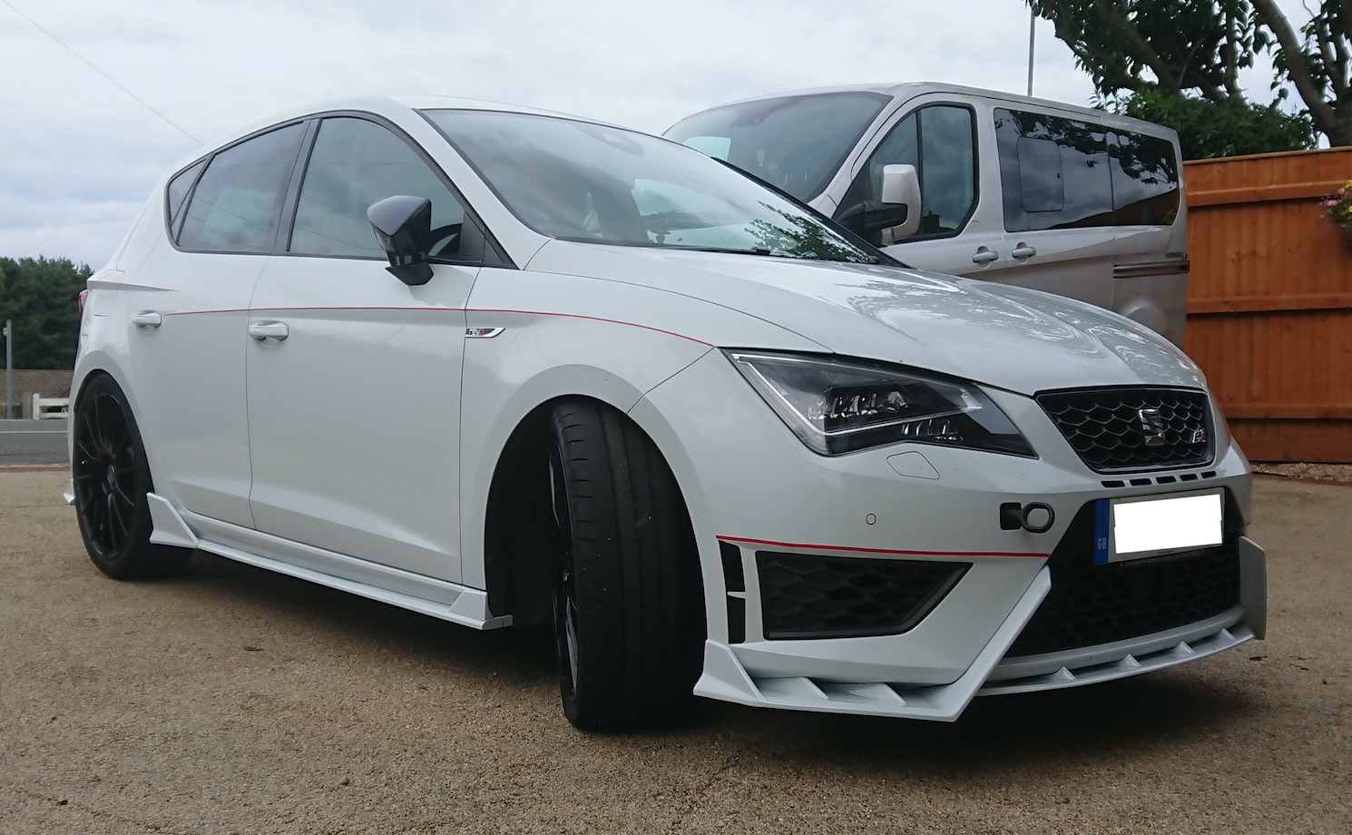 A car parked in a parking lot
Description automatically generated