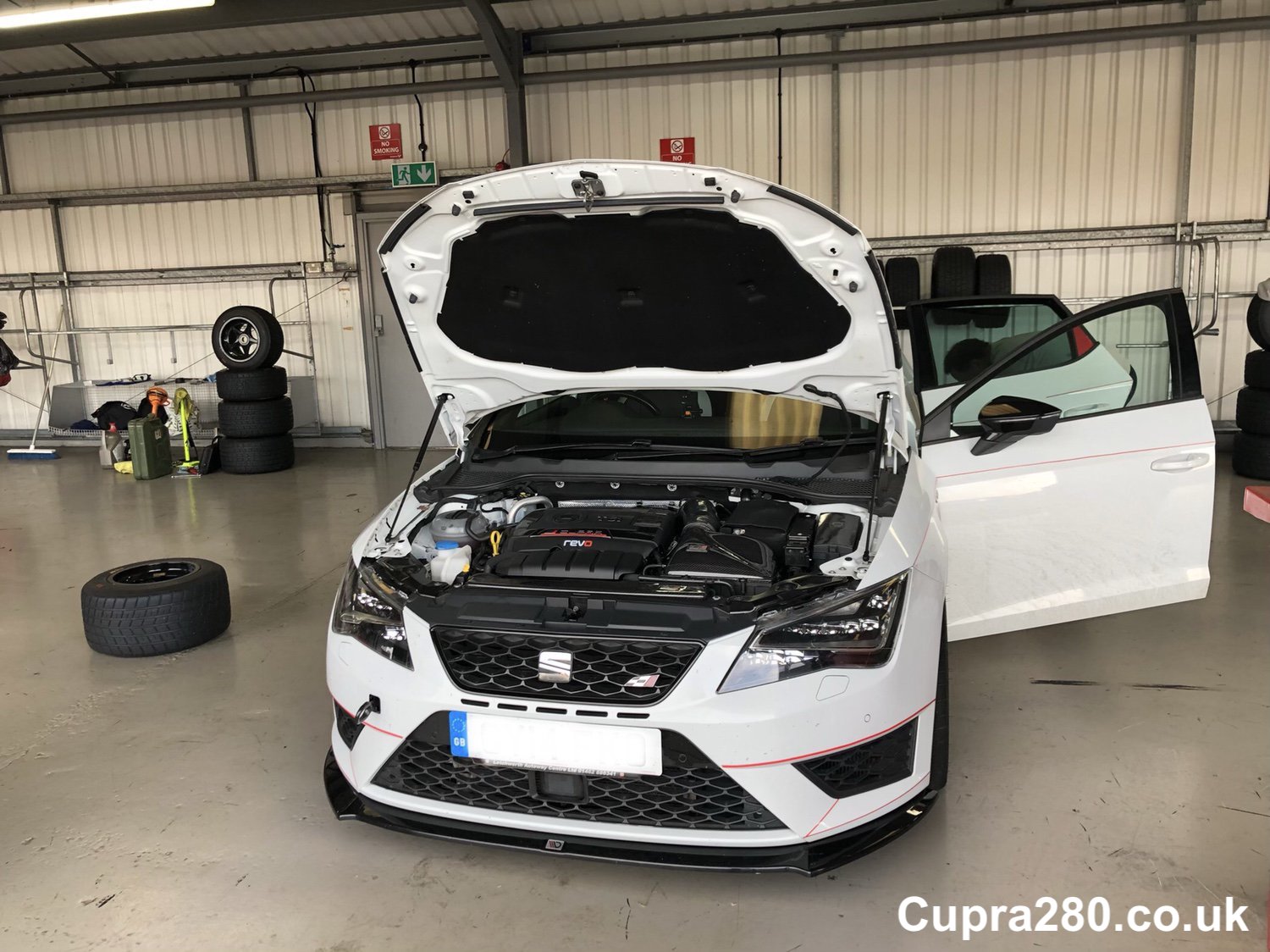 A car parked on the side of a building
Description automatically generated